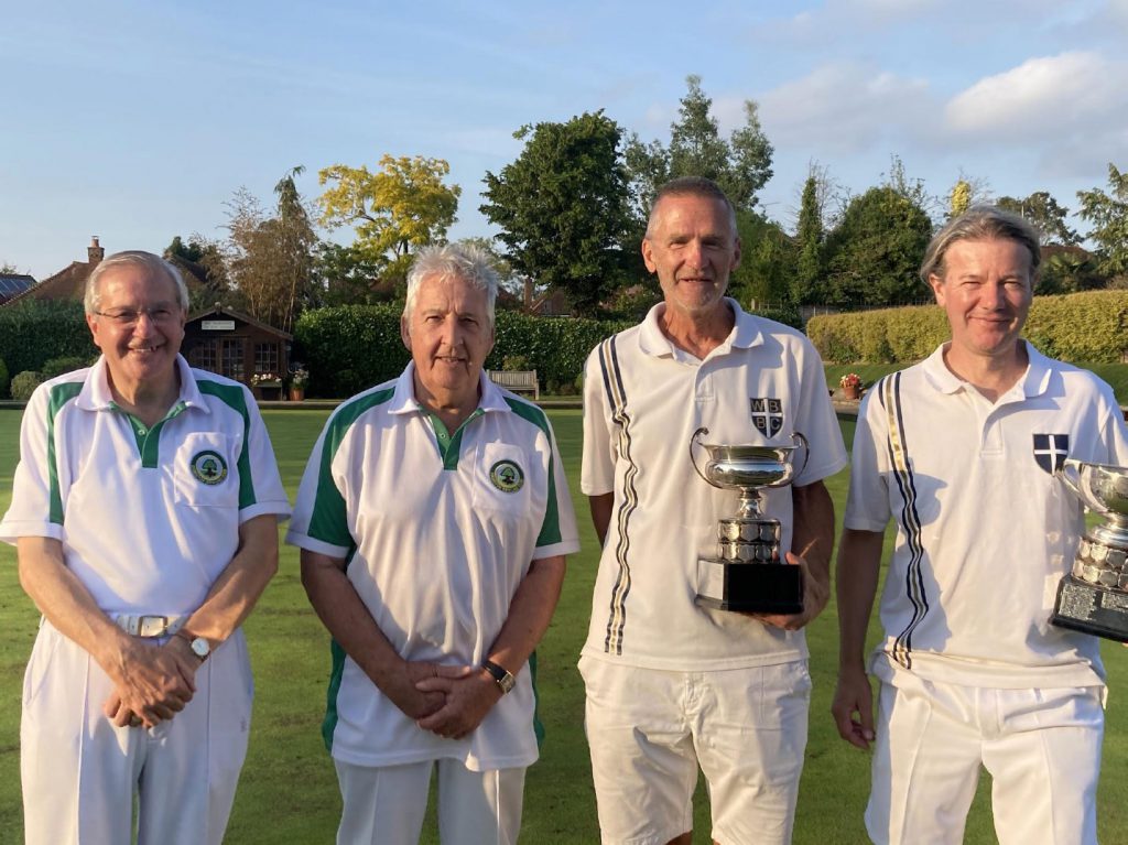 Kevin Bates and Karl Bunyan holding their pairs trophies, alongside opponents Tim Mould and Jim Wilson